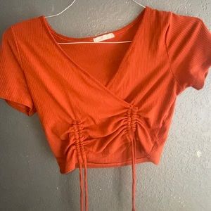 Maroon/orange crop top.